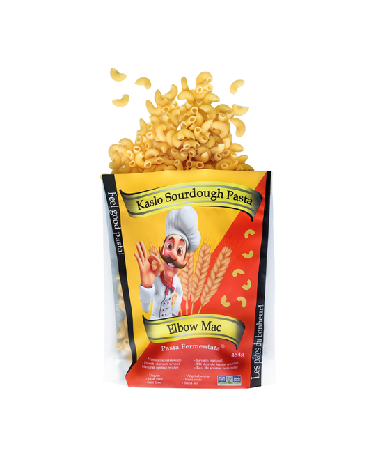A bag of Kaslo Sourdough Pasta Elbow Mac, showing the pasta pieces bursting out of the top of the package, set against a plain white background.
