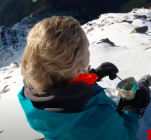 Heidi sitting on Mt. Loki eating Kaslo Sourdough. 